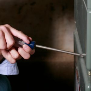 Technician in Round Rock inspecting a furnace