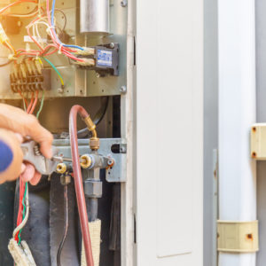 Handyman servicing a furnace in Round Rock TX